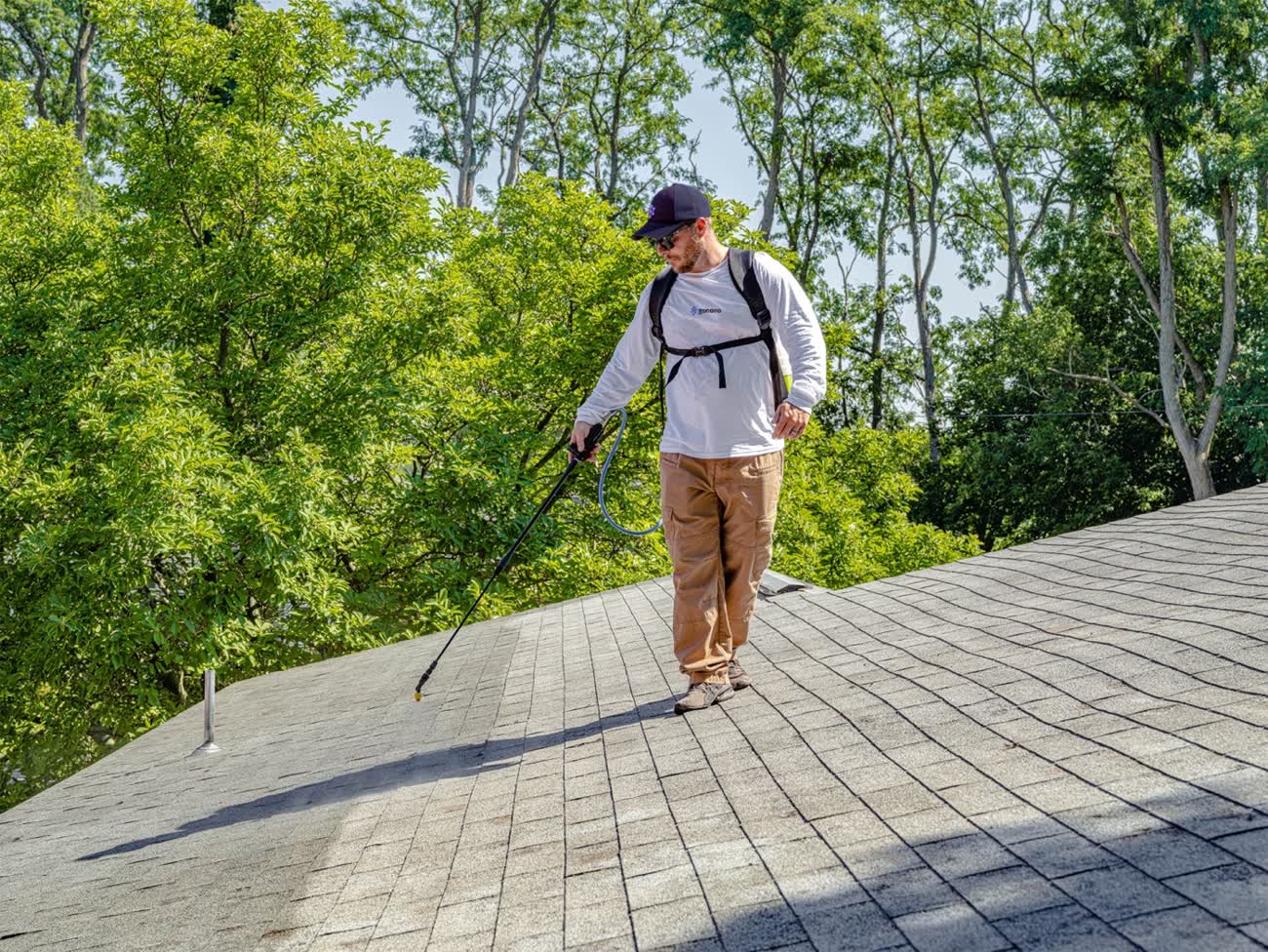 Nano Shield crew member working from a ladder on a Calgary shingle roof