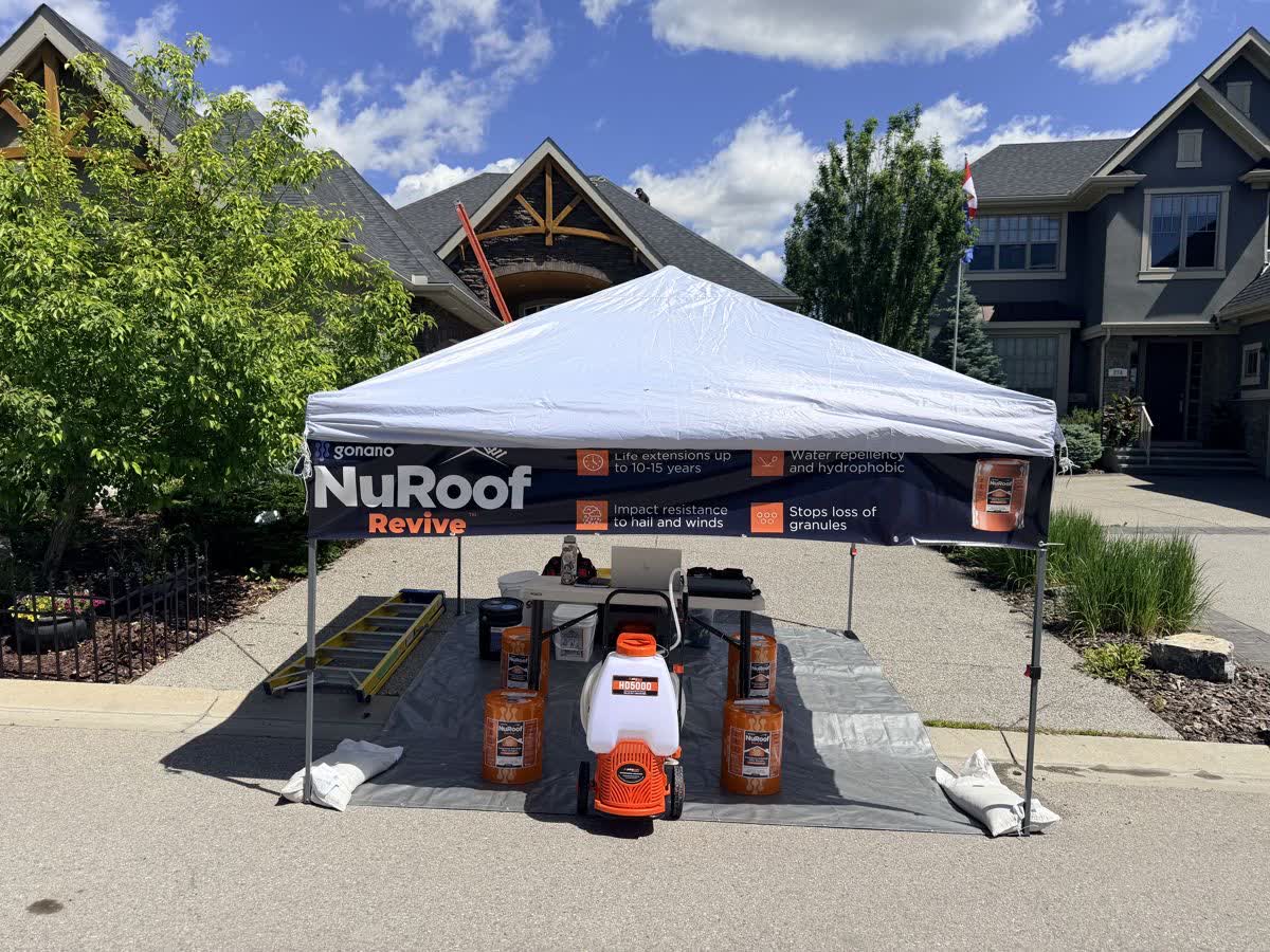 NuRoof branded tent and spray equipment at a Nano Shield job site in Calgary